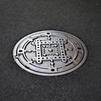 Unique manhole cover design on street