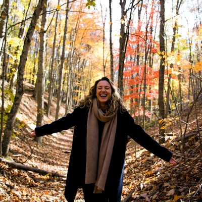 Woman enjoying autumn in the woods