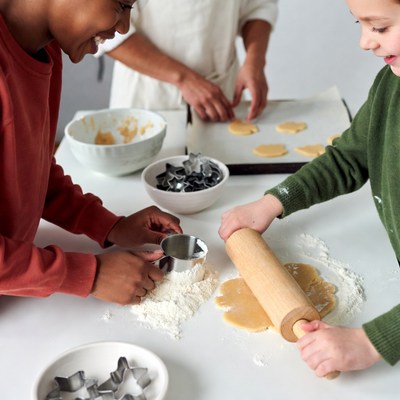 Group makes cookies in kitchen together