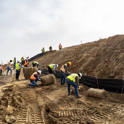Workers perform soil erosion control task