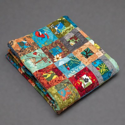 Colorful quilt with patchwork design displayed