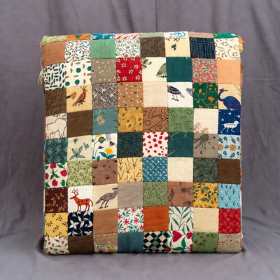 Colorful patchwork cushion on display