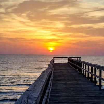 Sunset view from wooden pier at beach