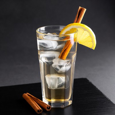 Glass of drink with lemon and cinnamon