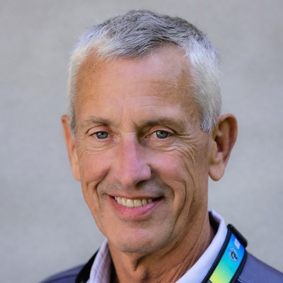 Smiling elderly man with rainbow lanyard