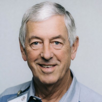 Smiling elderly man with name badge