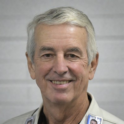 Smiling elderly man with ID badges