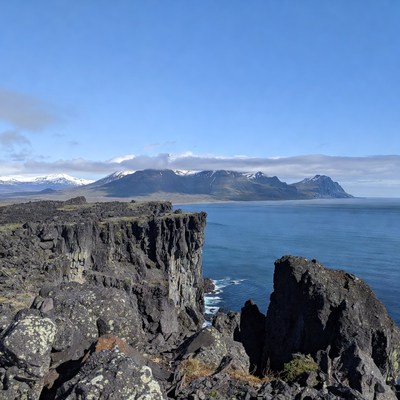 Basalt Cliffs Overlooking Ocean and Mountains