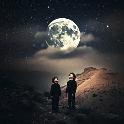 Two boys gazing at starry moonlit sky