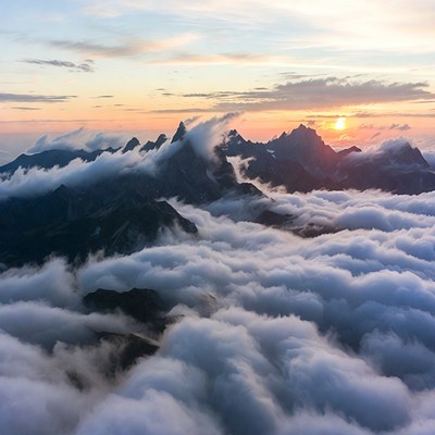 Sunset Over Cloud-Covered Mountains