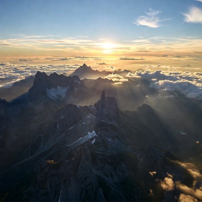Sunset Over Snowy Mountains Above Clouds