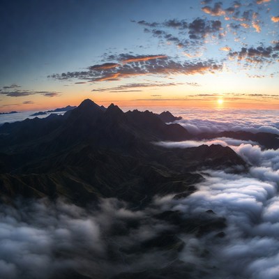 Mountains above clouds at sunset