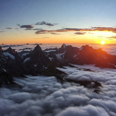 Sunset over Snowy Mountains Above Clouds