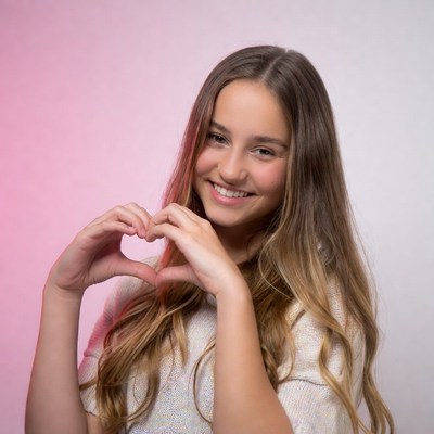 Teen girl making heart hands