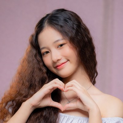 Asian girl making heart hands
