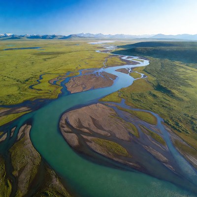 Aerial view of turquoise river in green tundra