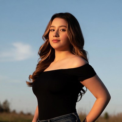 Young Latina woman in black off-shoulder top