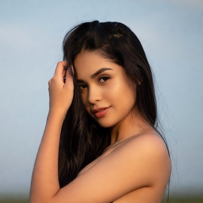 Latina woman touching face outdoors