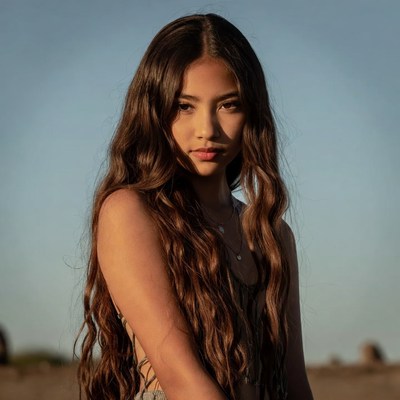 Asian woman with long wavy hair outdoors