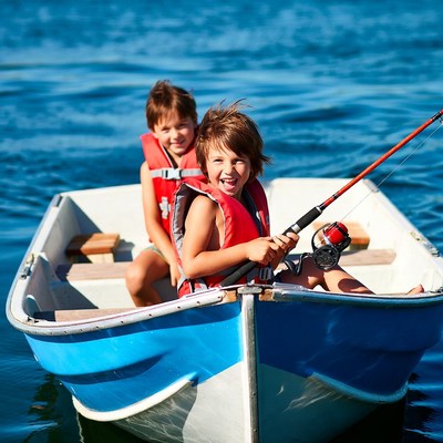 Boys fishing from small boat
