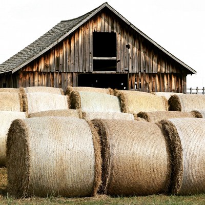 Hay Bales in Front of Wooden Barn