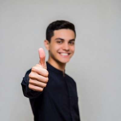 Young man giving thumbs up