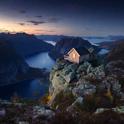 Cabin on Cliff Overlooking Fjords at Sunset