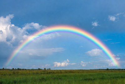 Vibrant Rainbow Over Green Field