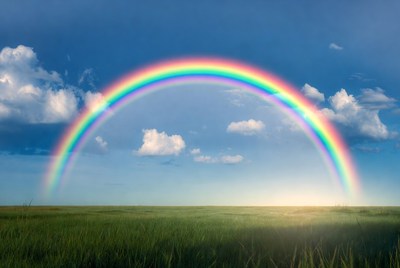 Rainbow over green field