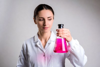 Woman scientist holding pink beaker