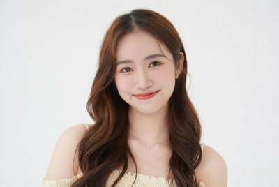 Asian woman smiling with long brown hair