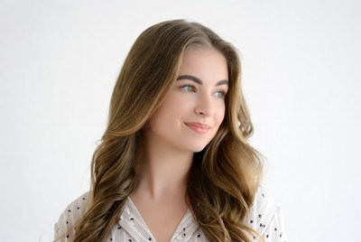 Smiling woman with wavy brown hair