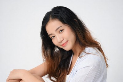 Asian woman smiling with brown hair