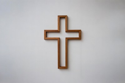 Wooden cross on gray wall