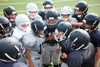 Football team huddle on field