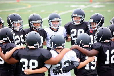 Football team huddle on field
