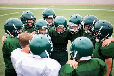 Football team huddle on field