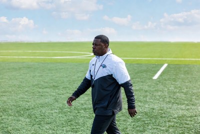 African-American man walking on football field
