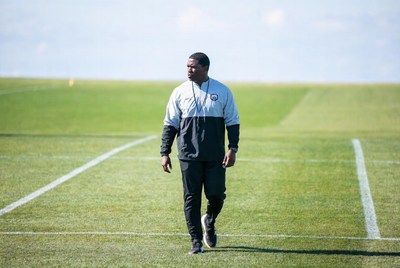 African-American man walking on soccer field