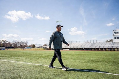 Coach walking on soccer field