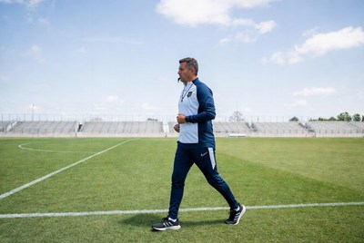 Soccer coach walking on field