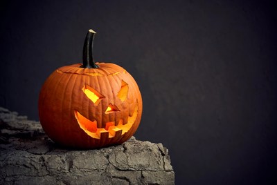 Lit Jack-o'-lantern on rocky surface