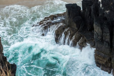 Ocean Waves Crashing on Black Rocks
