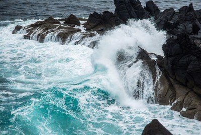 Ocean Waves Crashing on Black Rocks