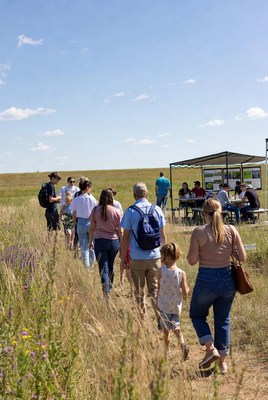 Group hiking through wildflower field