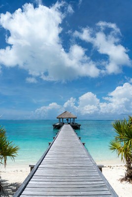 Wooden pier to tropical beach gazebo