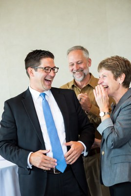Three people laughing together