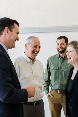 Group of four people laughing together