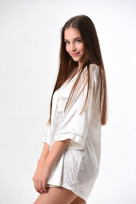 Young woman in white satin pajamas