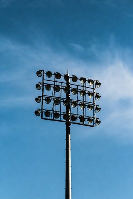 Stadium Floodlights Against Blue Sky